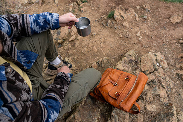 istock Hiker taking a break and drinking water in the mountains 2211007241