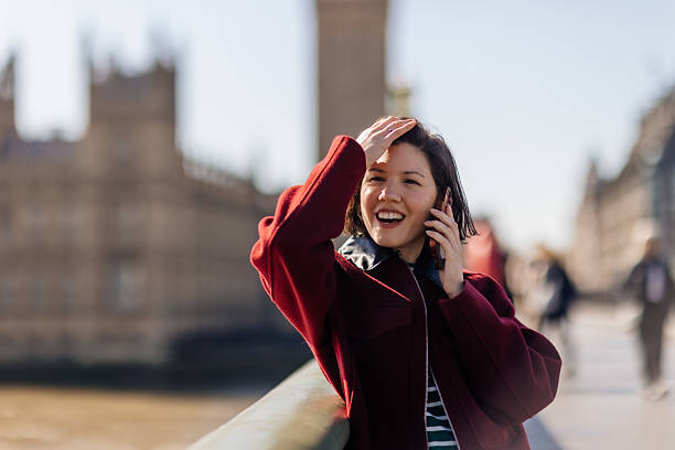 istock Woman using phone at Westminster in London 2211008890