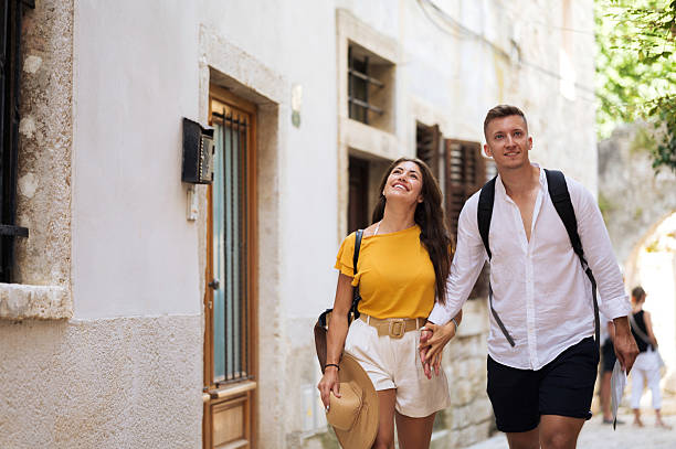 istock Young tourists walking and looking around the old city 2211009252
