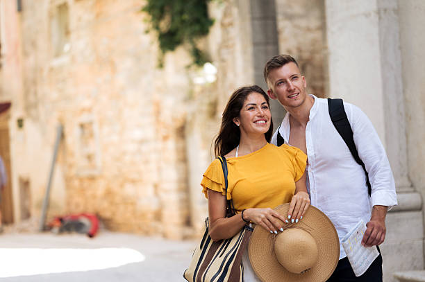 istock Young romantic couple walking throughout old town city 2211010075