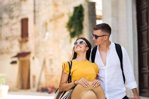 istock Young romantic couple walking throughout old town city 2211010101