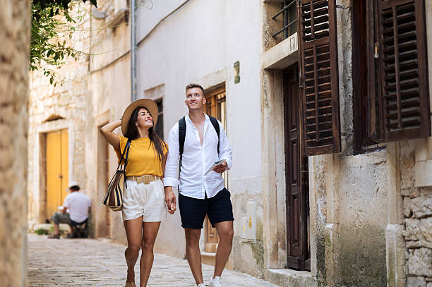 istock Young romantic couple walking throughout old town city 2211010133