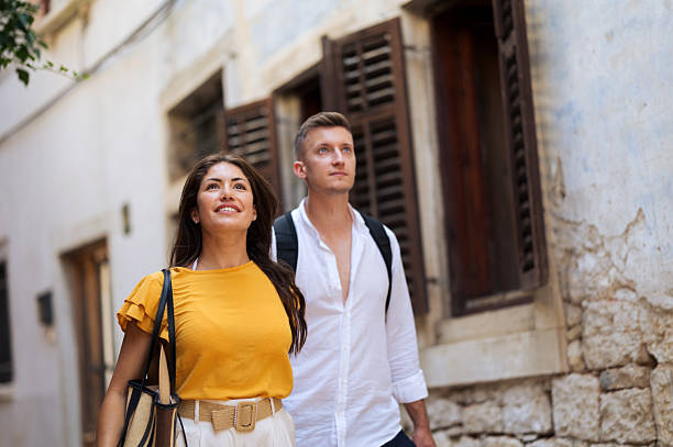 istock Young romantic couple walking throughout old town city 2211010169