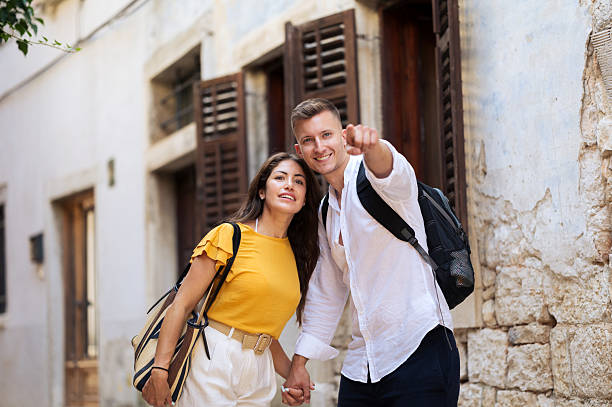 istock Young romantic couple walking throughout old town city 2211010183
