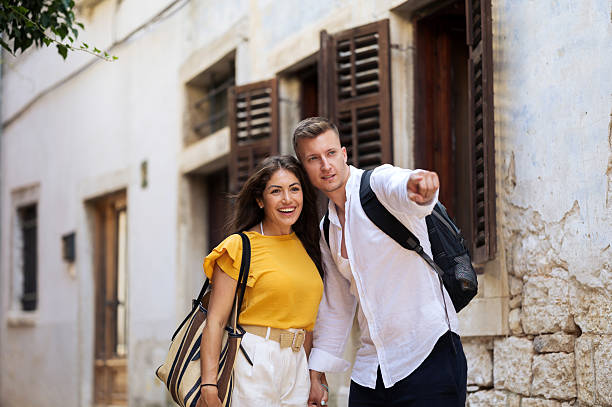 istock Young romantic couple walking throughout old town city 2211010199