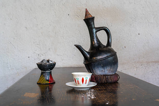 Ethiopia, traditional made coffee is served in a coffee pot and with burning incense.