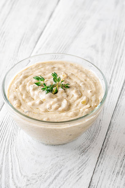 istock Creamy blue cheese sauce garnished with thyme in clear bowl on table 2211015585
