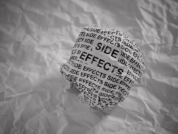 istock Crumpled paper ball with words Side Effects on crumpled white paper background. 2211018763