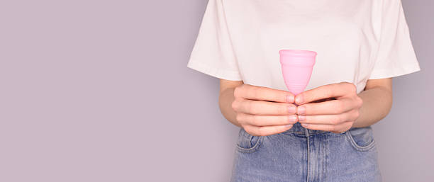 istock Banner with woman hold in hands pink menstrual cup. 2211018864