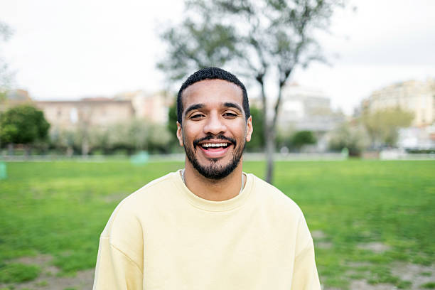 istock Young man smiling and enjoying a day in the park 2211024317