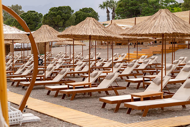 istock Beach chairs and umbrellas at sea beach 2211025262