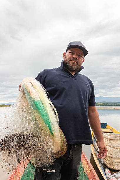 istock An artisanal fisherman looking at the camera 2211029408
