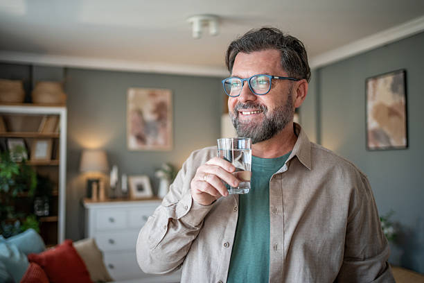 istock Happy mature man drinking fresh water at home 2211033397