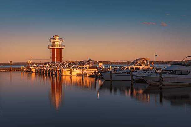 istock Marina with a lighthouse on the lake 2211041871