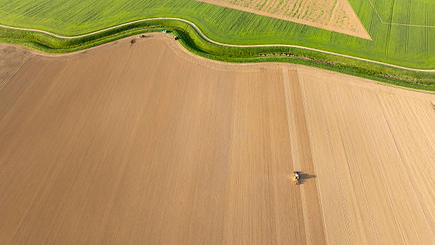 istock Tractor Planting Seeds on Vast Agricultural Field in Springtime 2211042684
