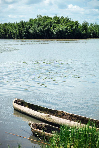 Lagoon scene with two traditional pirogues. Ouidah, Benin, West Africa