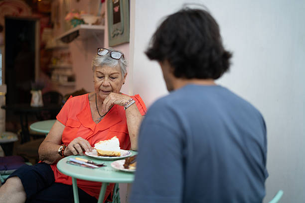 Grandmother and grandson enjoying lunch together at a cafe