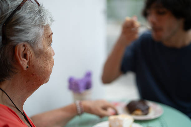 Grandmother and grandson enjoying lunch together at a cafe