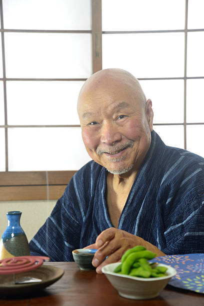 istock An elderly man lighting a mosquito coil and enjoying sake 2211047316