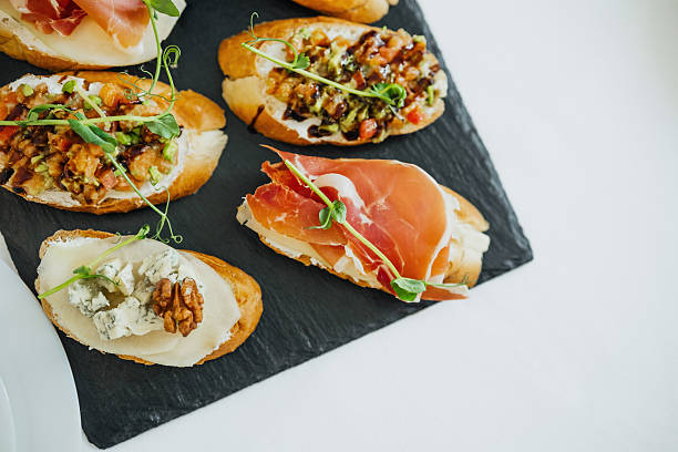 istock Delicious gourmet bruschetta served on a dark slate board 2211053684