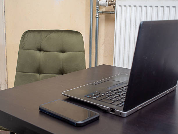 istock Desk with laptop and phone 2211055220