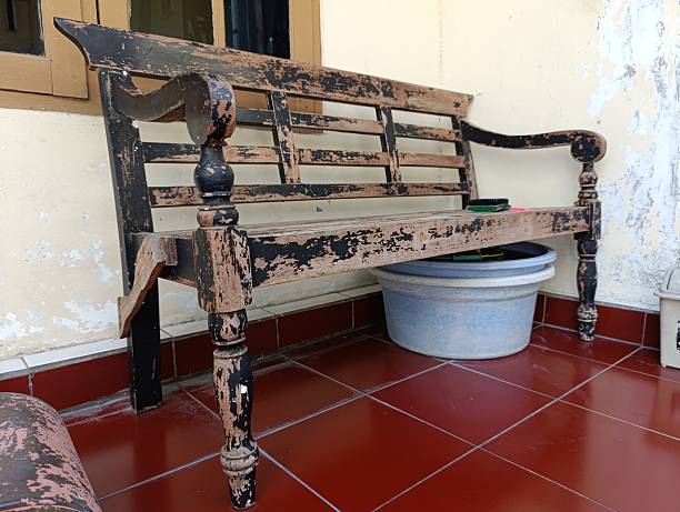 istock A weathered wooden bench sits outdoors on red tiles 2211057059