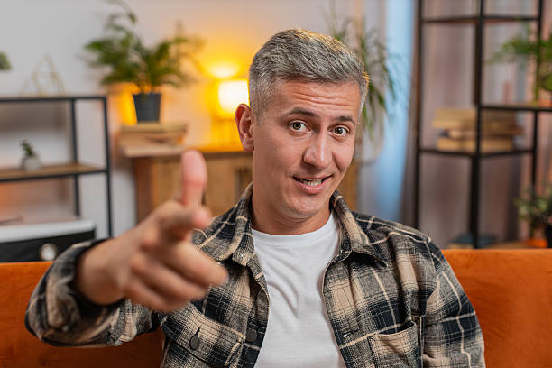 istock Happy satisfied man smiling pointing to camera, choosing lucky winner, indicating, inviting, approve 2211060647