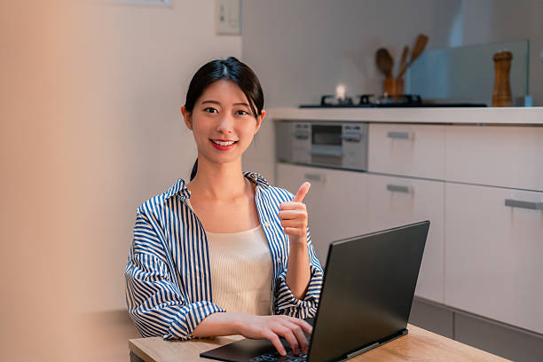istock Young woman working from home late at night 2211061242