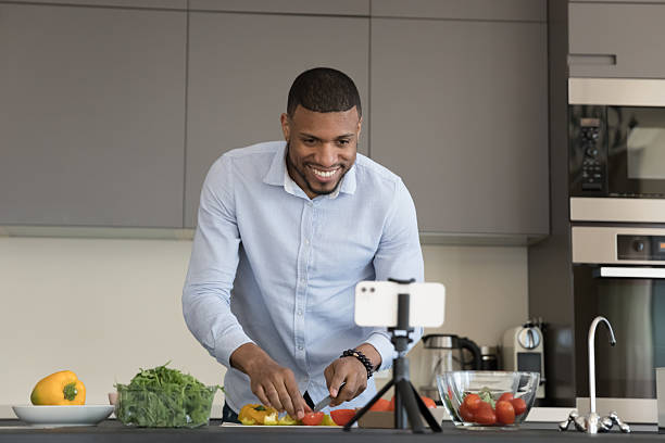 istock African vlogger record cooking class on smartphone camera 2211063831