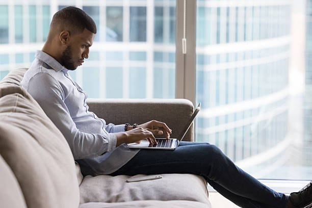 istock African man buys goods, typing e-mail, work on laptop 2211065045