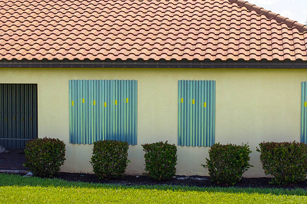 istock Boarded windows with storm shutters for hurricane protection of Florida home. Protective measures before natural disaster 2211065440