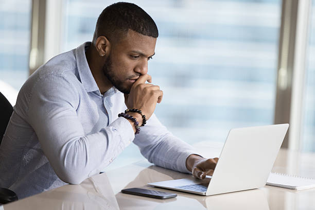 istock African businessman learns new software, working on project use laptop 2211065770