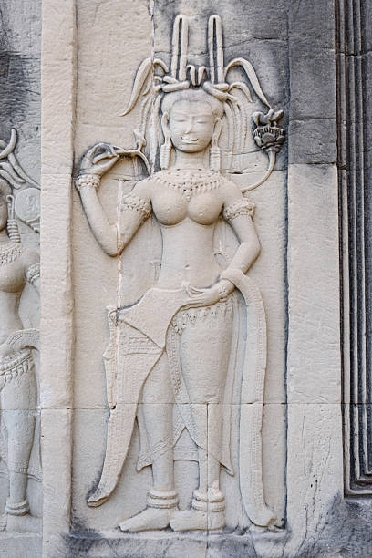 Apsara's stone carving at Ta Prohm temple in Angkor, Cambodia, the largest religious monument in the world by land area.