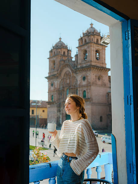 istock Woman drinking coffee looking at Plaza de Armas in Cusco, Peru 2211066343