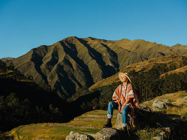 Woman in poncho  exploring in Urubamba valley during experential  trip to Peru