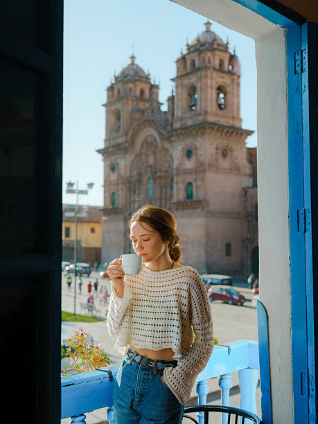 istock Woman drinking coffee looking at Plaza de Armas in Cusco, Peru 2211066355