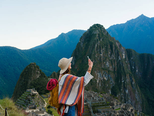 istock Woman using smartphone during trip to Machu Picchu in Peru 2211067105