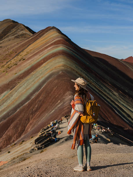 istock Woman looking at Vinicunca Rainbow mountain during trip to Peru 2211067132