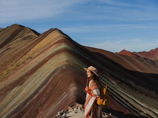 istock Woman looking at Vinicunca Rainbow mountain during trip to Peru 2211067134