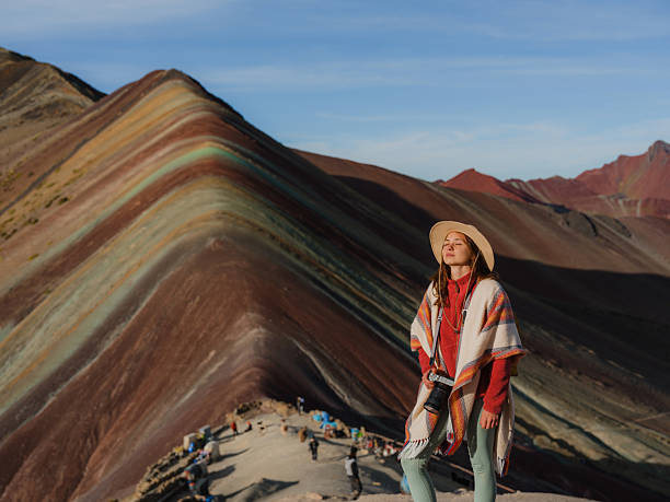 istock Woman looking at Vinicunca Rainbow mountain during trip to Peru 2211067135