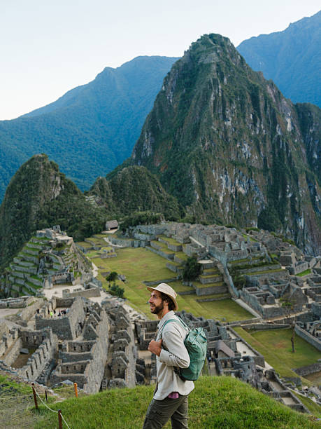 istock Man walking in Machu Picchu and looking at ancient Inca ruins 2211067165