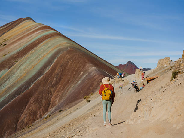 istock Woman looking at Vinicunca Rainbow mountain during trip to Peru 2211067267