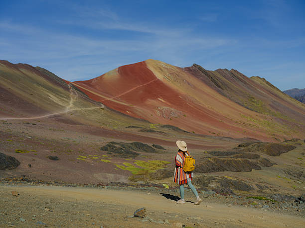 istock Woman looking at Vinicunca Rainbow mountain during trip to Peru 2211067724