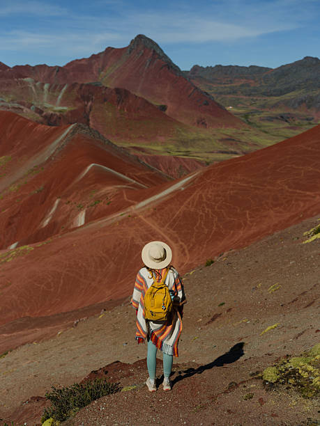 istock Woman looking at Vinicunca Rainbow mountain during trip to Peru 2211067758