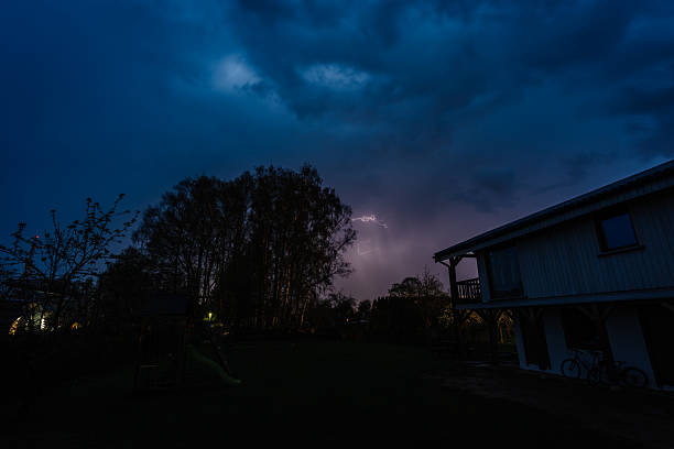 A dramatic lightning storm illuminates the night sky over Kissimmee, Orlando, highlighting the contrast between the natural phenomenon and urban lights.
