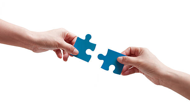 (clipping path) Two Puzzle Pieces Coming Together isolated