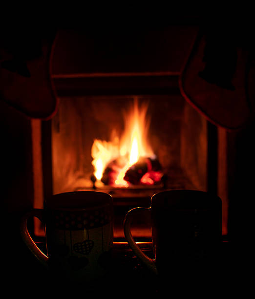 istock two mugs with fireplace with fire in the background relaxing and cozy 2211083019