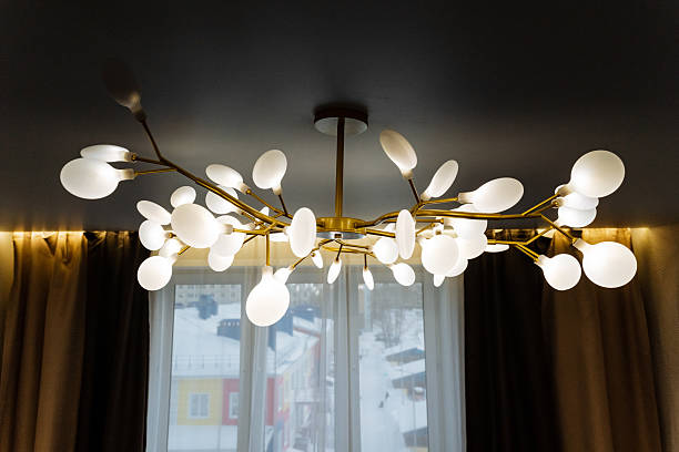 istock An intricately designed chandelier gracefully hangs from the living room ceiling, enhancing the decor and creating a warm, inviting atmosphere that welcomes family and guests alike 2211090163