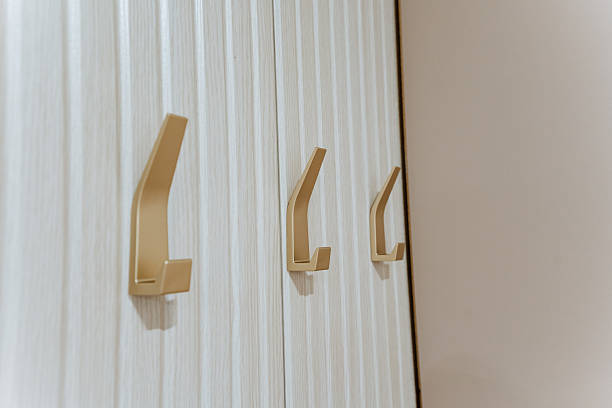 istock A row of sturdy wooden hooks on a bright white wall adds functionality and aesthetic appeal, enriching the rooms charm and creating a balance between practicality and design 2211090169