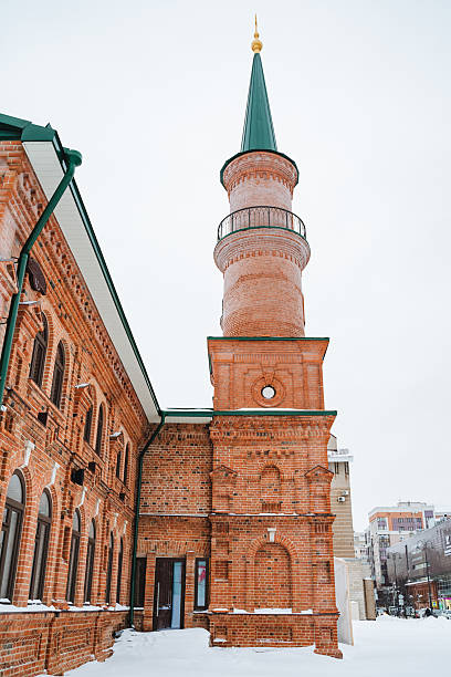 istock A tall, impressive brick building featuring a stunning green steeple rises majestically against a beautiful snowy backdrop, creating a picturesque winter scene that is admired by everyone 2211090196